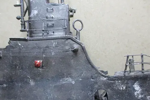 Close up of USS Wahoo submarine model conning tower with weathered surface and fittings