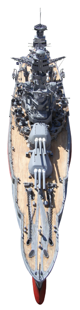 Overhead frontal view of a scale model of the USS Arizona, showing the forward deck, main gun turrets, and superstructure details.