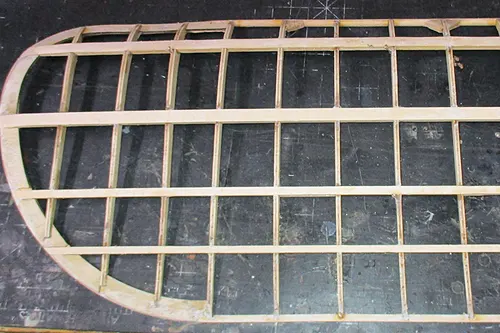 Top view of a Blériot model aircraft wing under construction showing spars, ribs, and structural framework