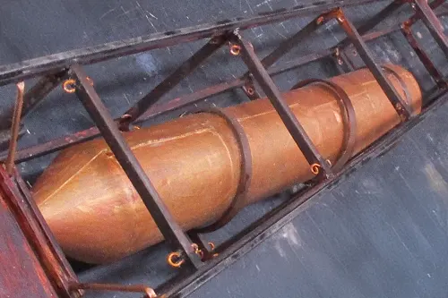 Close-up of a Blériot model airplane showing the copper fuel tank and surrounding framework