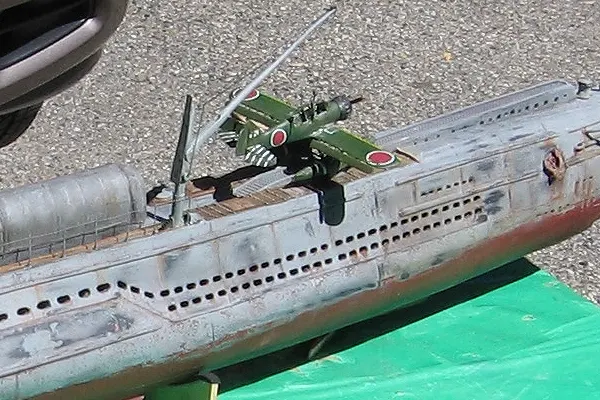 Model of I 21 submarine with a Japanese floatplane on the bow held by a crane preparing for launch