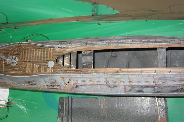 Scratch built submarine model hull with deck planking and a single deck gun installed before the conning tower is added