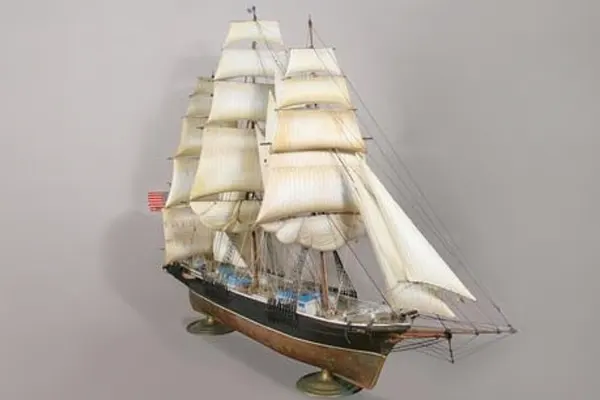 Scale model of the clipper ship Sea Witch with full sails rigged, displayed on brass stands
