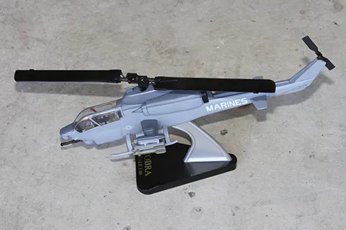 Super Wings Marine Corps Cobra attack helicopter prototype toy model displayed on a stand