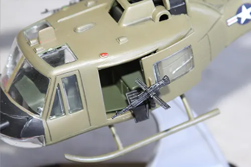Close-up of Super Wings UH 1 Huey prototype showing side gunner door and mounted machine gun detail