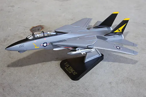 Super Wings F 14 Tomcat prototype toy model displayed on a stand in flight position