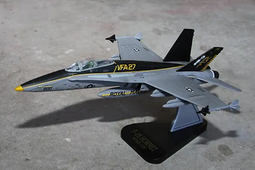 Super Wings F A 18 Hornet prototype toy model displayed on a stand in flight position
