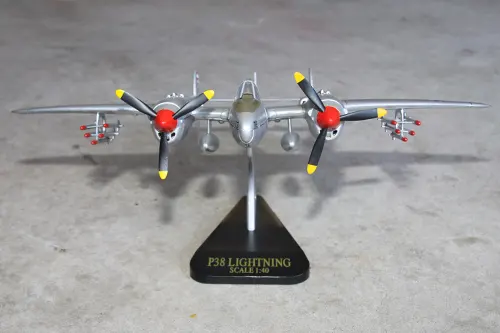 Head-on view of Super Wings P-38 Lightning prototype toy model mounted on a display stand