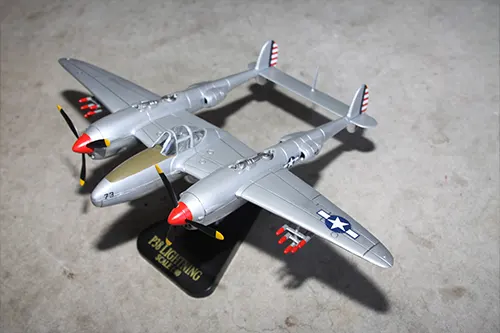 Super Wings prototype P-38 Lightning toy model displayed on a stand in flight position