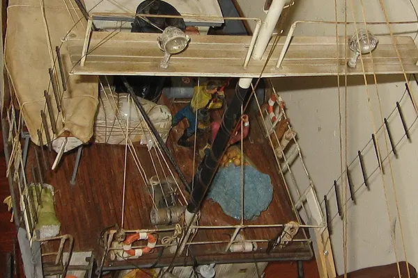 Detailed view of tuna boat model deck with rigging, mast, lights, and fishing equipment during construction