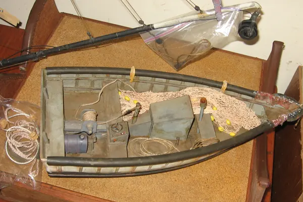 Small tuna fishing skiff model with net, motor, and gear arranged for launch