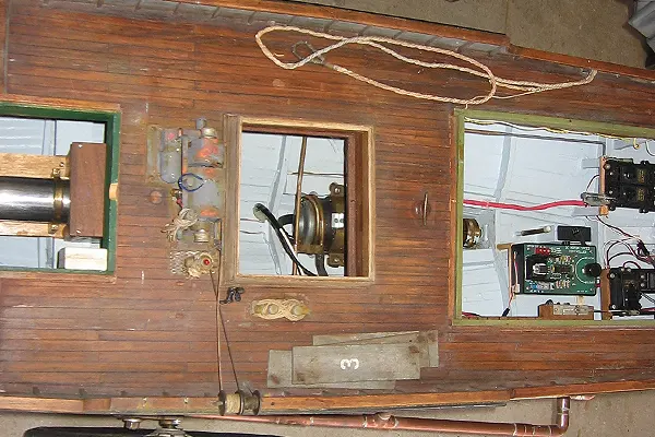 Close up of tuna boat deck with exposed mechanical components and equipment visible through open sections